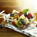 A fresh and colorful breakfast fruit salad with a mix of seasonal fruits