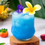 Blue Hawaiian Mocktail in textured glass with lime and flower